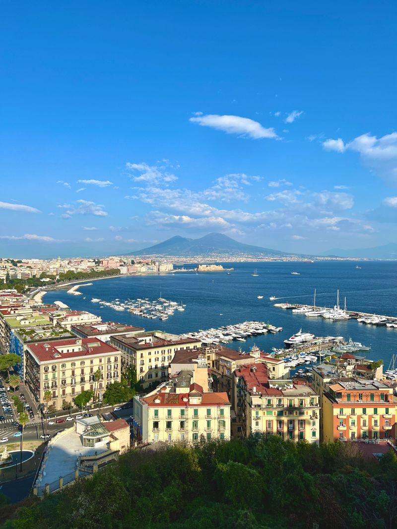 Naples harbor with Mount Vesuvius, evoking the Italian ports of departure